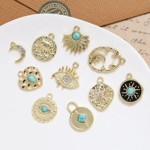 Set of 10 vintage gold alloy pendants with turquoise eyes and moon designs