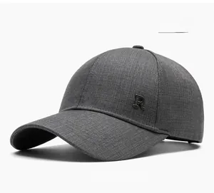 Detail of dark grey baseball cap featuring coarse canvas texture and metal R logo