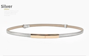 Close-up of thin silver PU leather belt with a shiny gold rectangular metal buckle