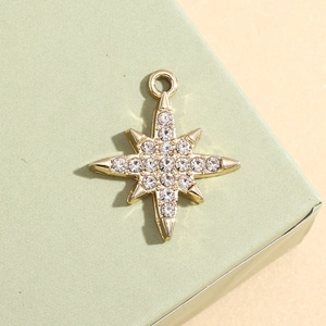Macro detail of a 18K gold star pendant with sparkling cubic zirconia inlay