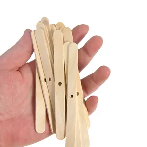 Detailed macro view of natural wooden candle wick holders with central pre-drilled holes