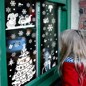Christmas window decals with Santa, reindeer and tree displayed on a cozy festive window