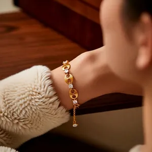 Luxury gold plated zircon chain bracelet with hollow round links on a female model wrist
