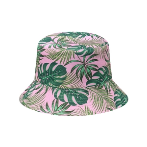 Close-up of tropical monstera leaf print on a pink summer bucket hat for beach style