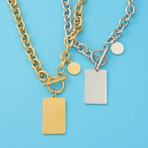 Detail of gold and silver chunky chain necklaces with OT buckle and square pendant