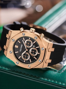 Macro shot of rose gold octagonal watch case with black dial and rubber strap