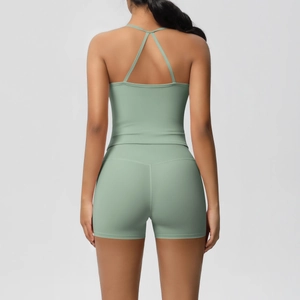 Close-up back view of high-waist yoga shorts and cross-back sports bra set in sage green
