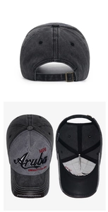 Detailed view of washed grey cotton baseball cap with Aruba embroidery and metal adjustment buckle