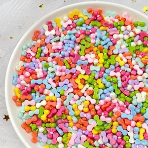 Colorful resin bow charms for DIY nail art in assorted pastel shades on a white plate