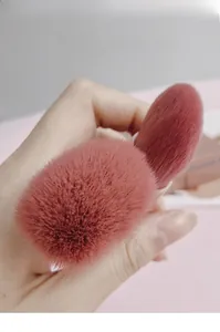 Close-up of soft pink makeup brush bristles showing fine texture and density