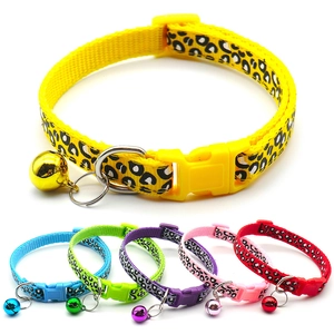 Close-up of leopard print pet collars with secure plastic buckles and jingling bells
