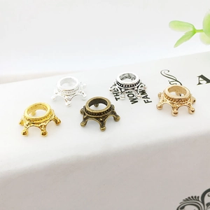 Detailed close-up of 3D alloy crown charms in various vintage metallic finishes