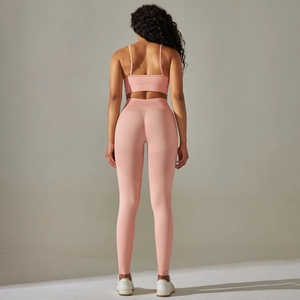 Pink seamless yoga set with cross back sports bra and high-waisted leggings back view