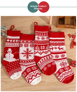 Close-up of four knitted Christmas stockings with reindeer and snowflake patterns