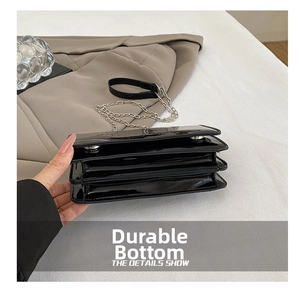 Macro view of durable wear-resistant bottom on black laser finish chain crossbody bag