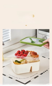 Detail view of double-layer bento box with sauce compartment and fork spoon storage