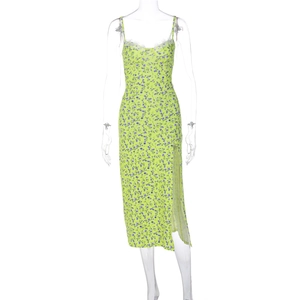 Detailed view of lime green floral dress with white lace trim and side slit design