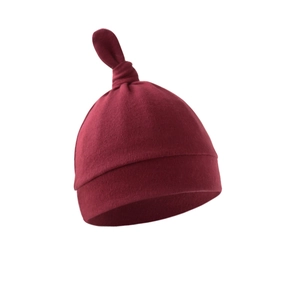 Detail view of cotton newborn knot hat in burgundy with folded brim on white background