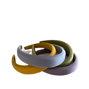 Set of four pastel padded headbands in yellow, lilac, gray, and olive green matte fabric