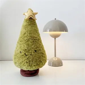 Detail of Christmas tree plush toy with golden star top and plush olive green fabric texture