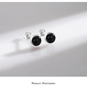 Macro detail of S925 sterling silver black onyx stud earrings with clear hallmark stamp