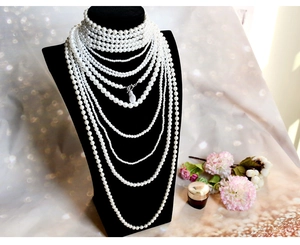 Detailed layered baroque pearl necklaces arranged on black velvet jewelry display stand