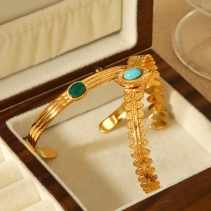 Vintage gold plated stainless steel open bangles with green and blue oval gemstones