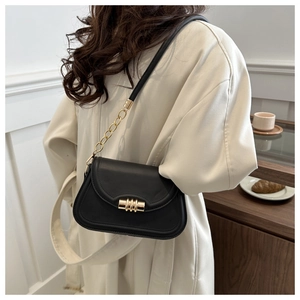 Chic black leather saddle bag with gold metal hardware and chain strap for women