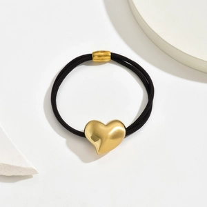 Elegant elastic hair tie featuring a polished gold heart charm and durable black band