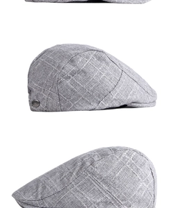 Détail de la casquette plate grise à carreaux montrant la texture lin et le bouton en métal