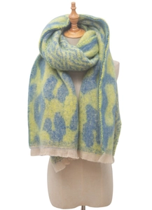 Close-up of yellow and blue leopard print knit scarf with soft tassel edges on a mannequin