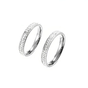 Close-up detail of silver titanium steel rings with sparkling mud drill texture