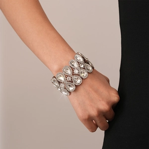 Close-up of a luxury silver-toned wide stretch bracelet with teardrop-shaped rhinestones