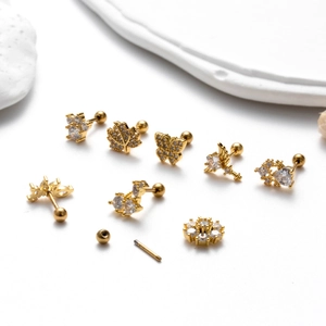 Golden stainless steel earring set featuring butterfly and heart shapes with cubic zirconia