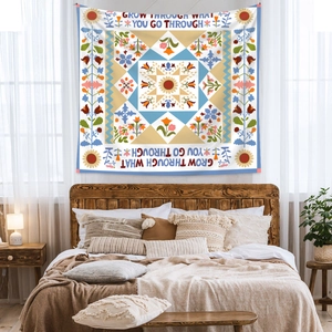 Detail of bedroom tapestry with floral pattern and Grow Through What You Go Through text