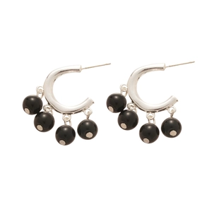 Silver C-shaped hoop earrings with four smooth black spherical beads in a modern design