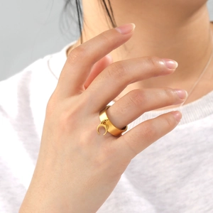 6mm gold titanium steel wide ring with crescent moon pendant shown on female finger