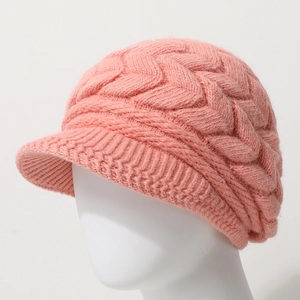 Pink chunky cable knit beanie with brim for women, warm winter hat on model