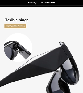 Detail of sunglasses featuring flexible metal hinges and high gloss black frame finish