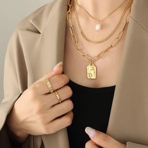 Three-layer gold layered necklace set with freshwater pearl and rectangle face relief pendant