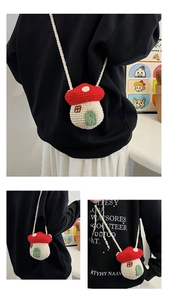 Detail showing hand-knitted mushroom crossbody bag with red roof and green door detail