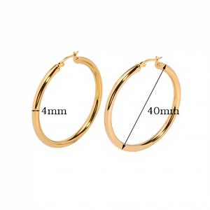 Detail shot of 4mm thick gold hollow hoop earrings with 40mm diameter on white background