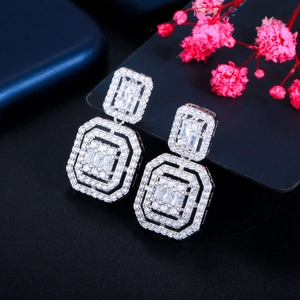 Detailed macro view of S925 silver geometric earrings with sparkling zircon crystals