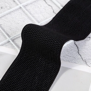 Macro shot of black elastic waist belt featuring premium woven texture for dresses