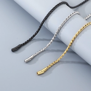 Close-up of basket weave chains in black, silver, and 18K gold plated stainless steel