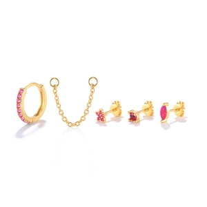 Macro detail of S925 silver gold plated earring set with pink zircon floral studs