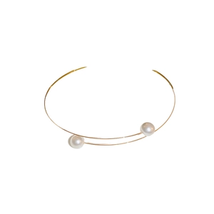 Minimalist gold metal choker necklace with elegant large white pearls on a white background