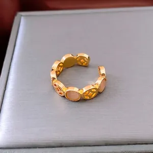 Vintage Chinese copper coin hollow ring with pink cat eye stone in golden finish