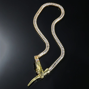 Luxury gold serpent necklace with square cubic zirconia on a sleek black background