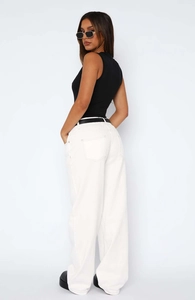 Detailed view of white straight-leg denim trousers with contrast stitching and pocket texture